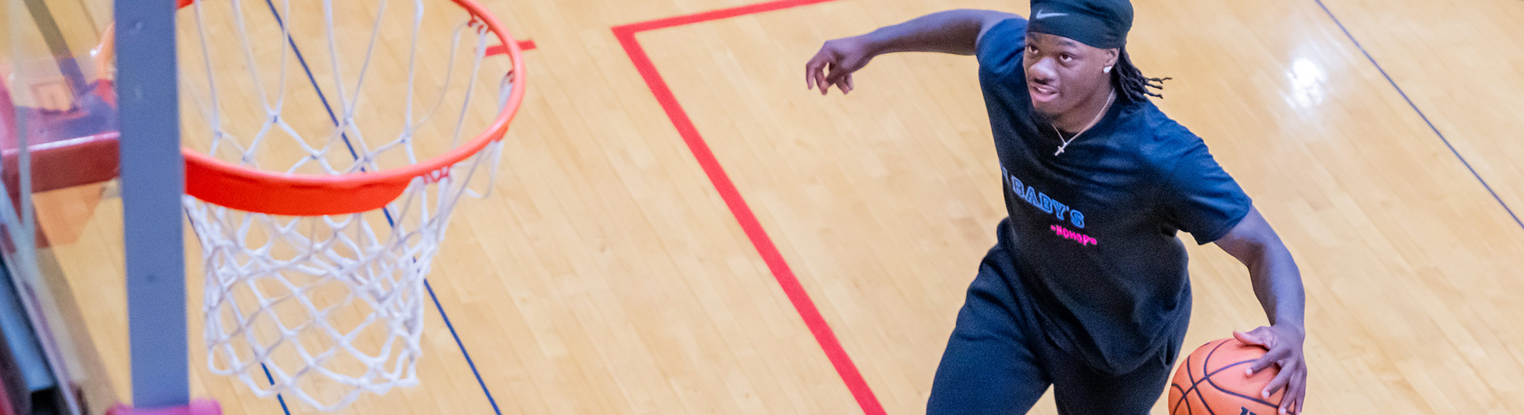 Student playing basketball.
